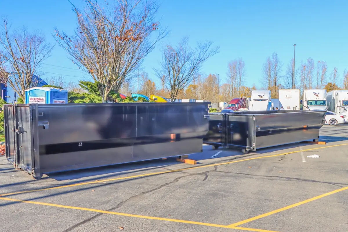 Professional dumpster rental service with roll-off container on residential driveway in Cockeysville